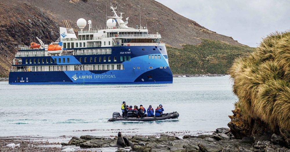 Albatros Expeditions ship with Zodiac and sea lions ashore