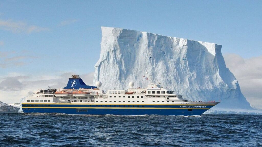 Heritage Expeditions Heritage Adventurer ship next to tabular iceberg